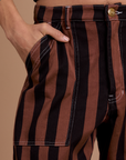 Close up of Anthony's hand in the front pocket of Black Stripe Work Pants in Fudgesicle Brown