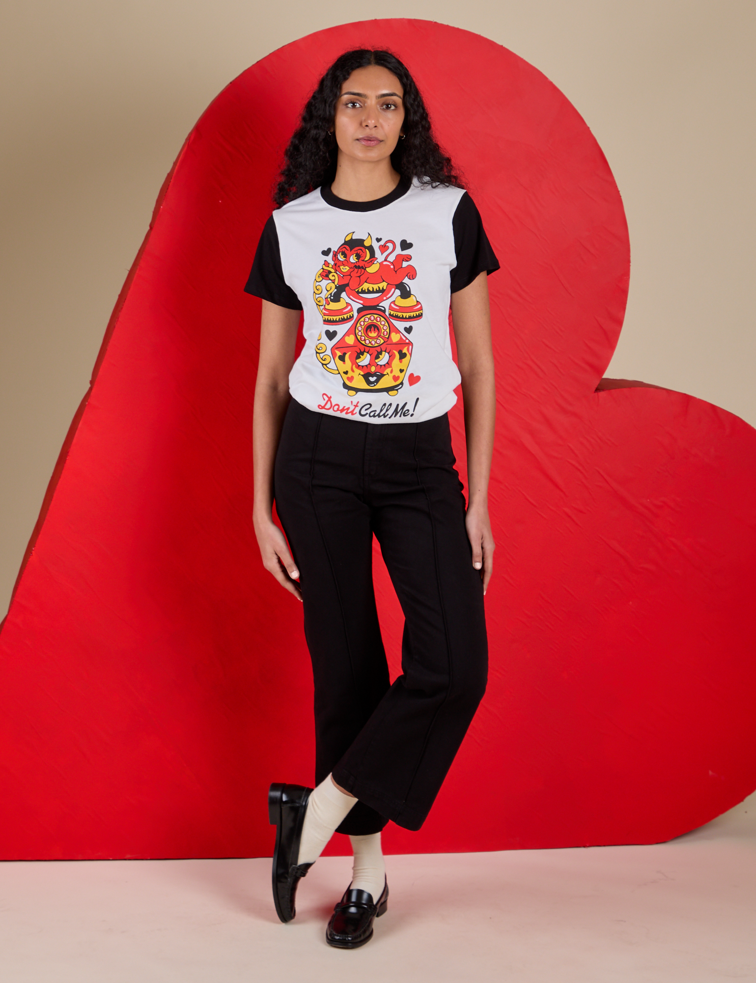 Shahana is wearing Vintage Tee in Don't Call Me tucked into black Western Pants