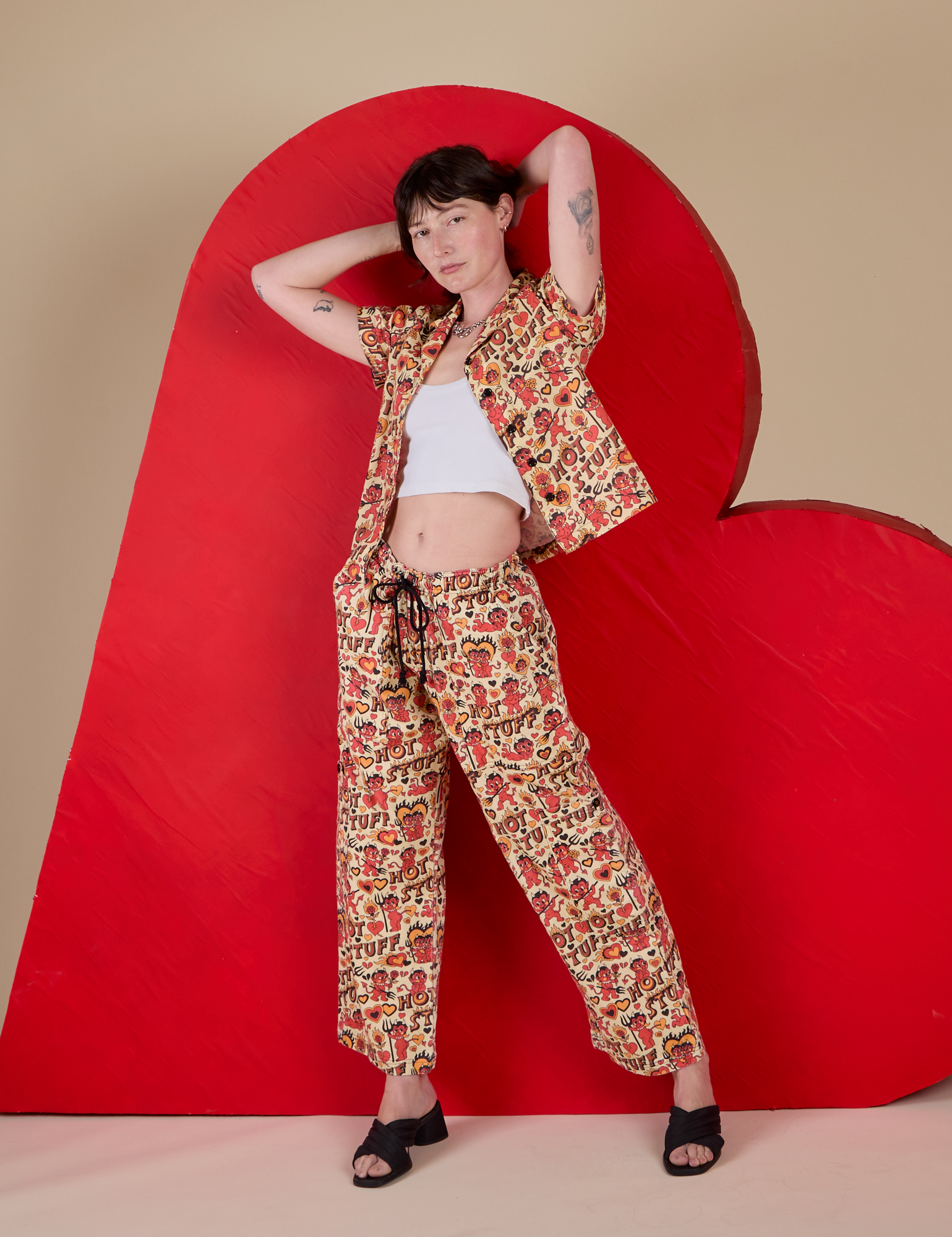Alex is wearing  Hot Stuff Drop Pocket Cargo Pants paired with matching Pantry Button-Up