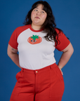 Ashley is wearing Produce Raglan Tee in Tomato tucked into mustang red Work Pants