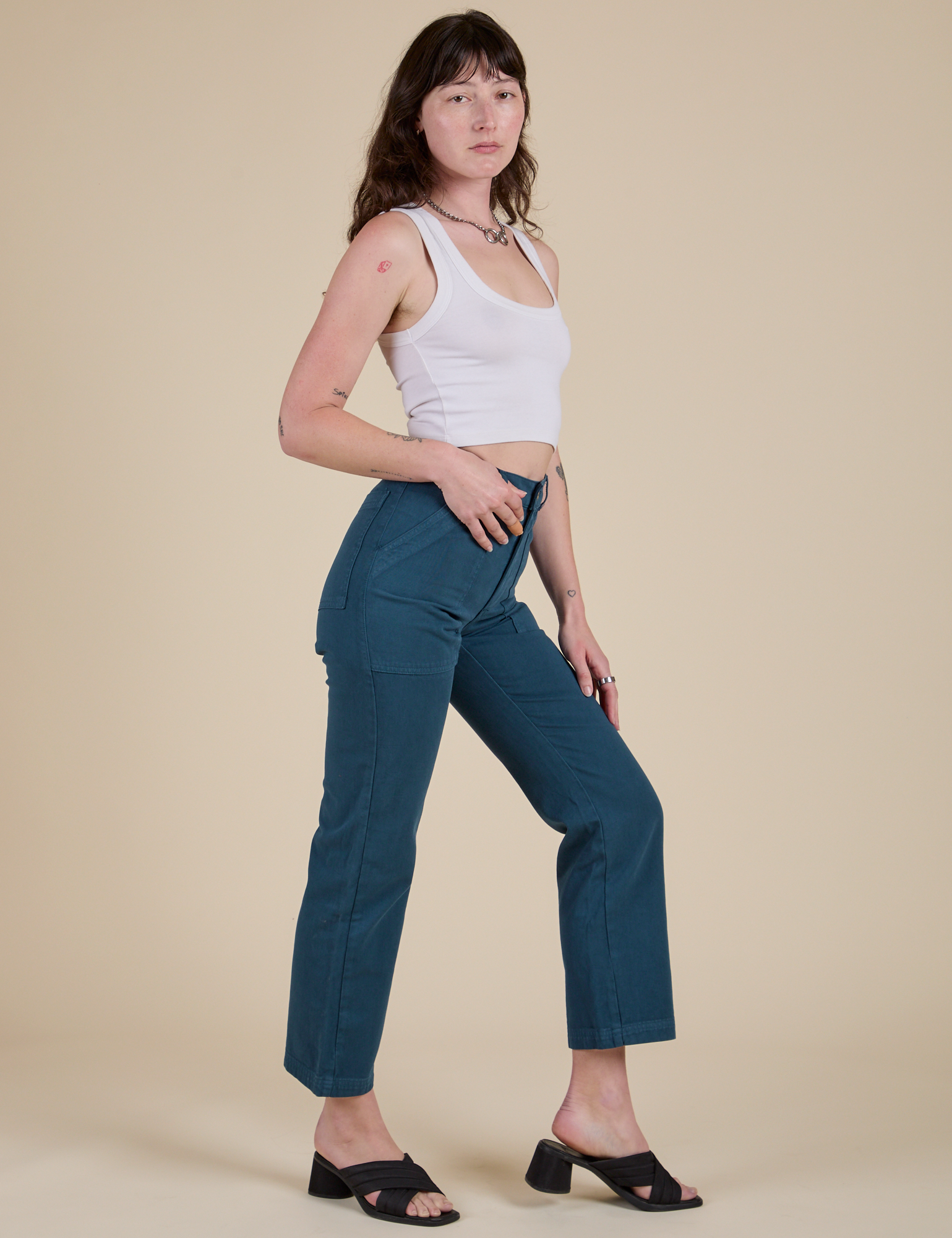 Side view of Work Pants in Lagoon and vintage tee white Cropped Tank on Alex