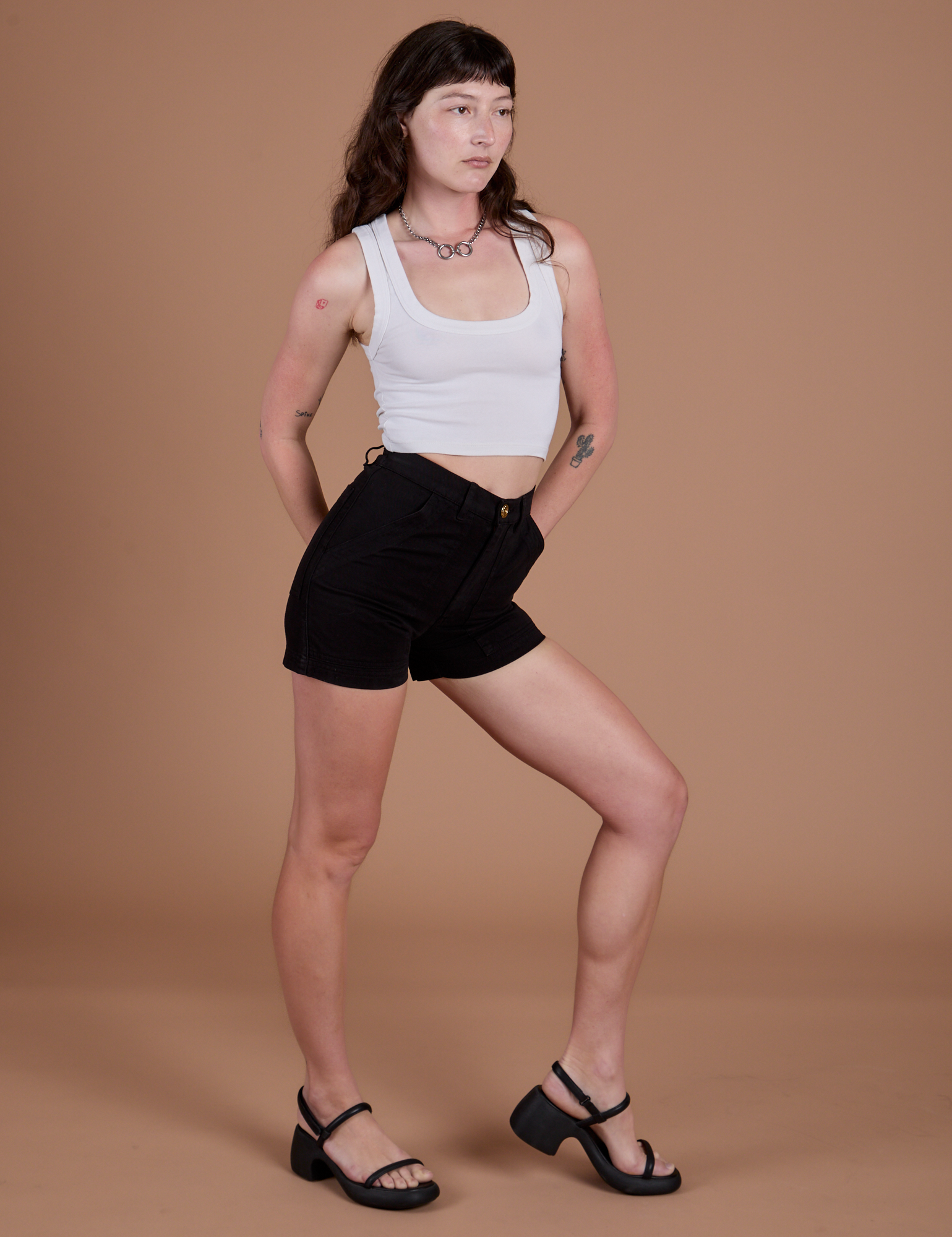 Angled front view of Classic Work Shorts in Basic Black and Cropped Tank in Vintage Tee White