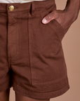 Close up of Isaac's hand in the front pocket of Classic Work Shorts in Fudgesicle Brown