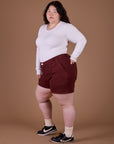 Side view of Classic Work Shorts in Red Wine and vintage tee white Long Sleeve Baby Tee on Ashley