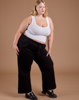 Angled front view of Organic Action Pants in Basic Black and vintage tee white Cropped Tank on Juliet