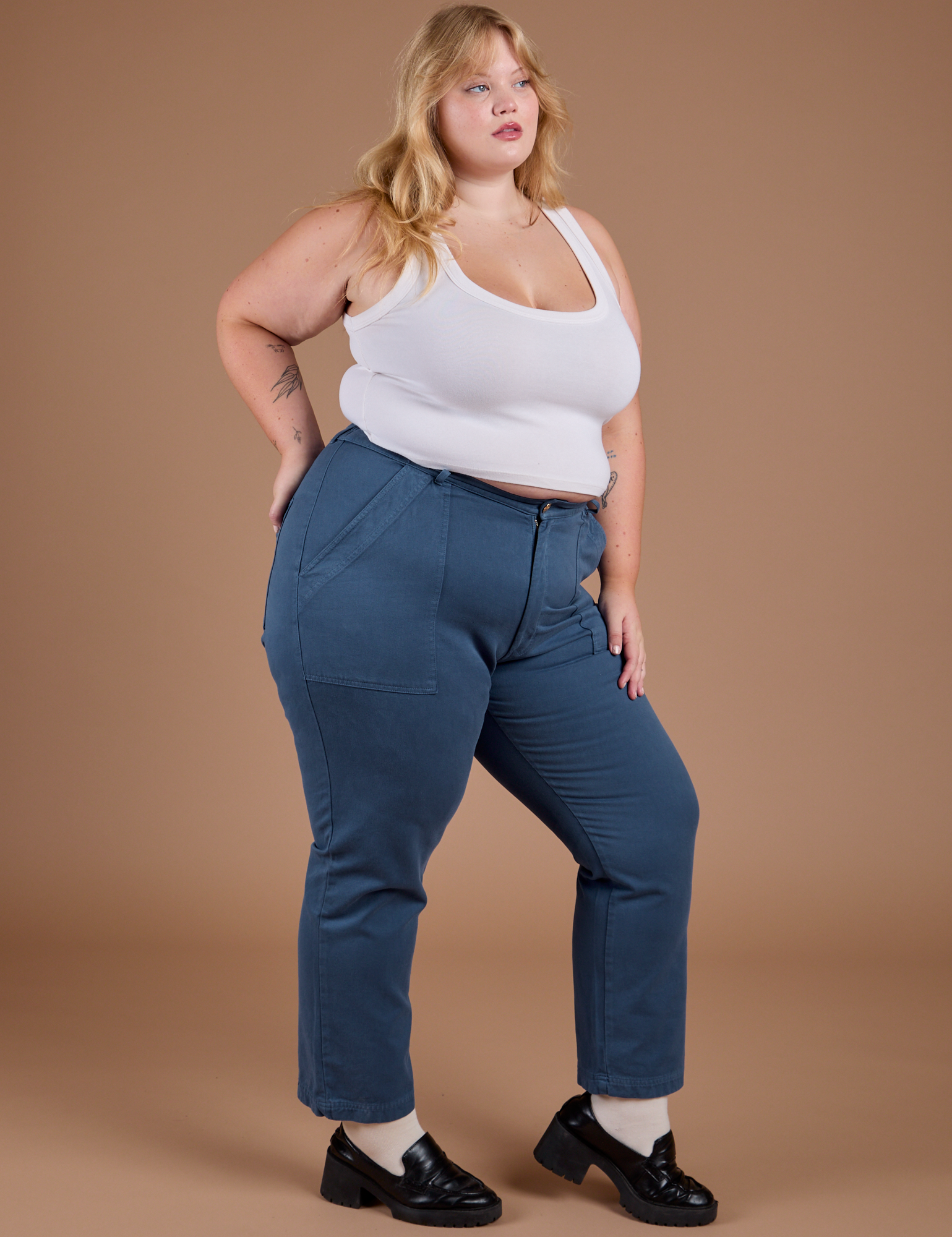 Angled front view of Organic Work Pants in French Blue and vintage tee white Cropped Tank on Juliet