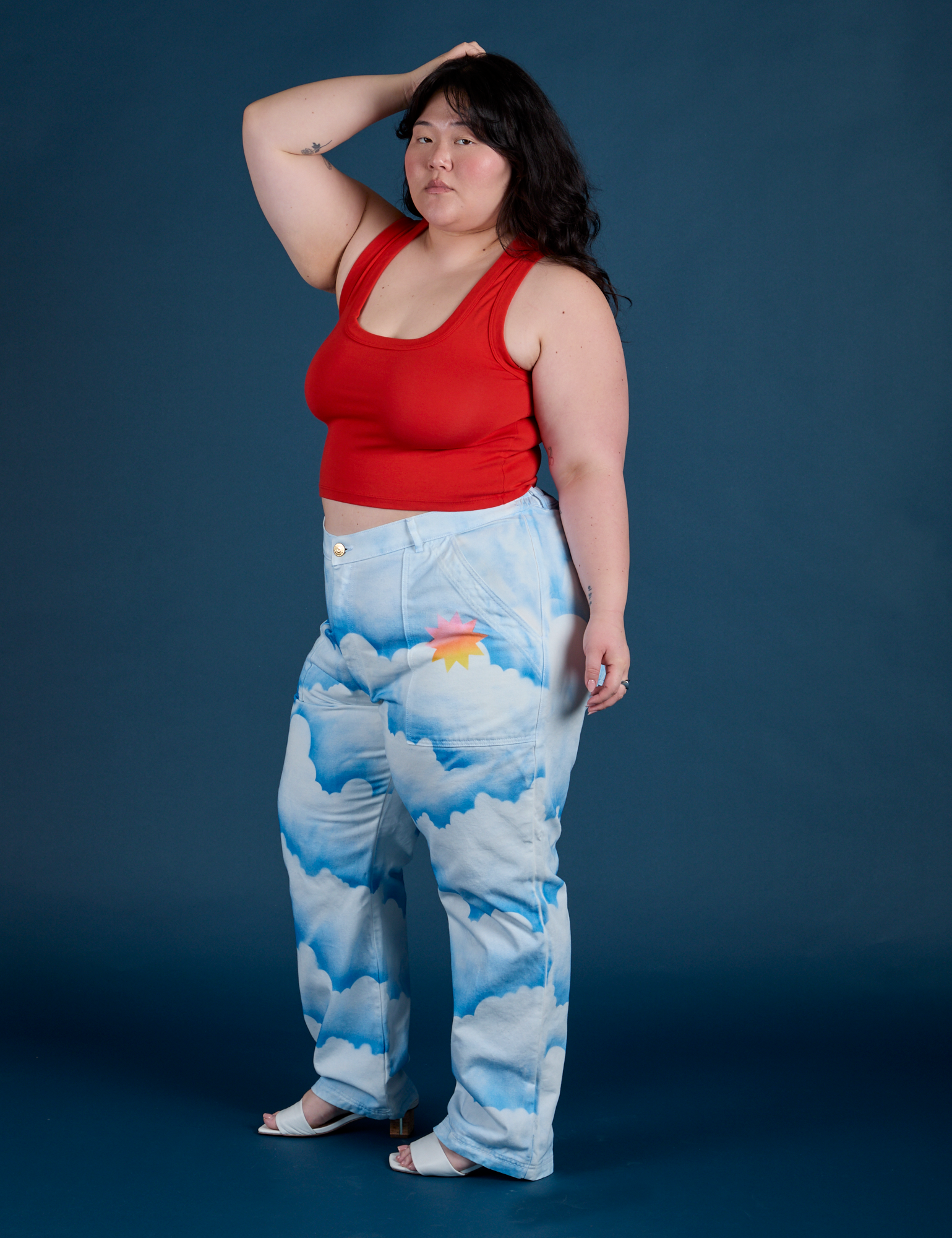 Side view of Work Pants in Sunny Cloud Airbrush and mustang red Tank Top on Ashley