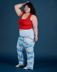 Side view of Work Pants in Sunny Cloud Airbrush and mustang red Tank Top on Ashley