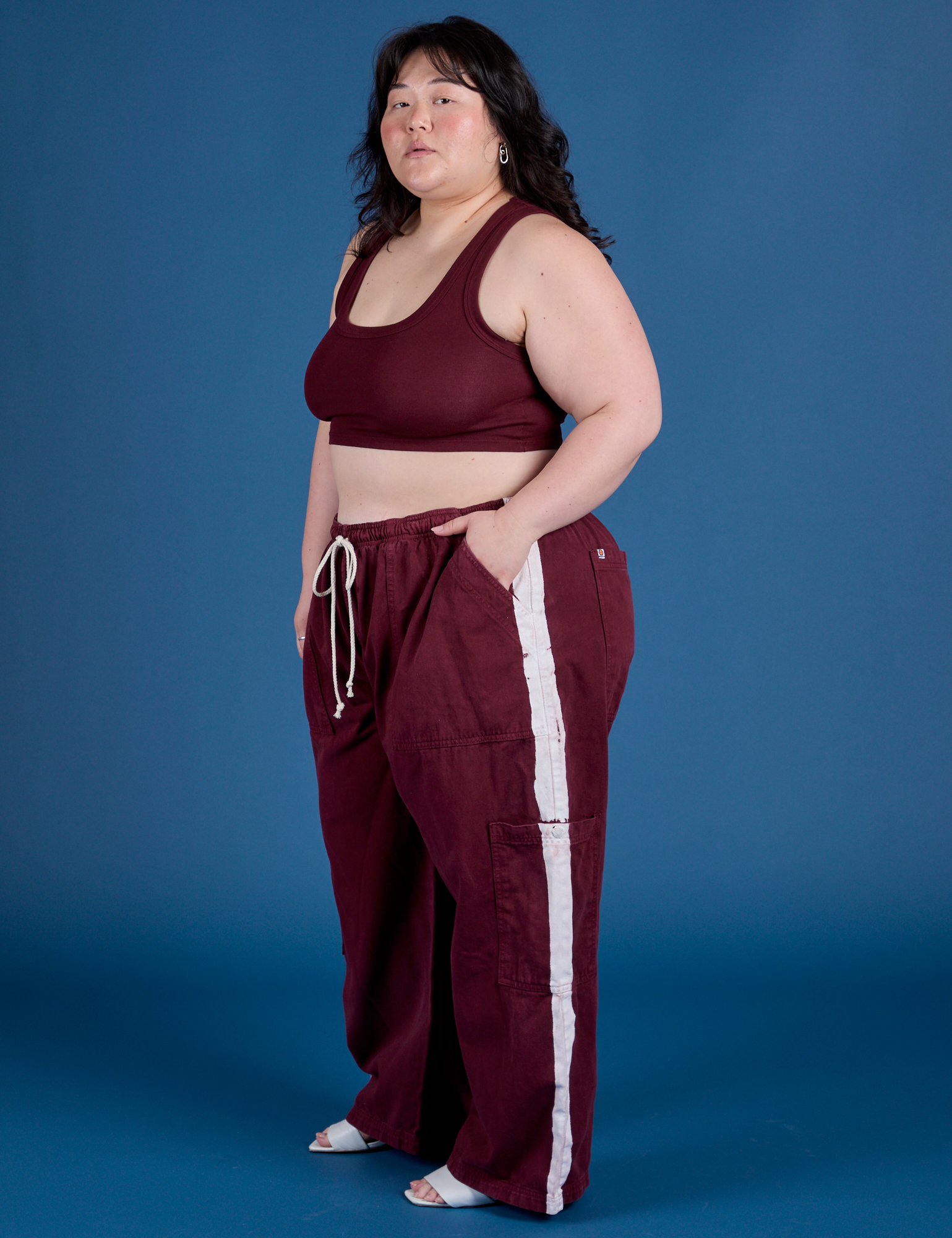 Side view of and Painted Drop Pocket Cargo Pants in Red Wine matching Mini Tank on Ashley