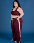 Side view of and Painted Drop Pocket Cargo Pants in Red Wine matching Mini Tank on Ashley