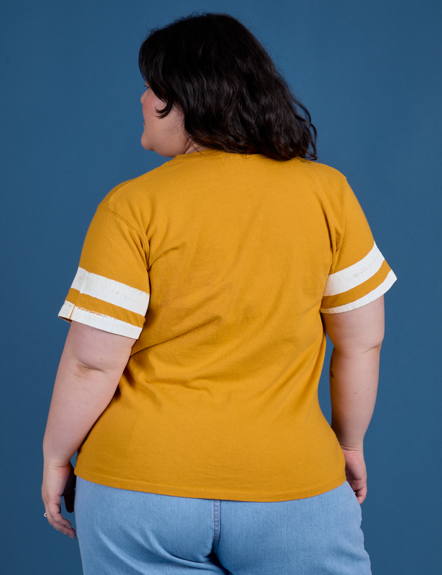 Painted Burly Tee in Mustard Yellow back view on Ashley