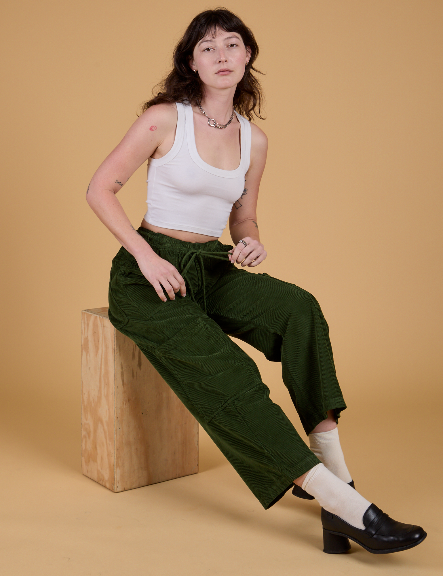 Corduroy Drop Pocket Cargo Pants in Evergreen and Cropped Tank in Vintage Tee White worn by Alex