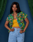 Kandia is 5'3" and wearing P Pond Party Pantry Button-Up