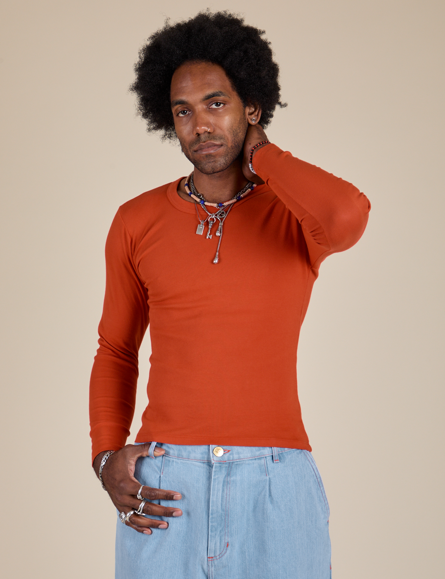 Jerrod is 6’3” and wearing S Long Sleeve Baby Tee in Chili Red 