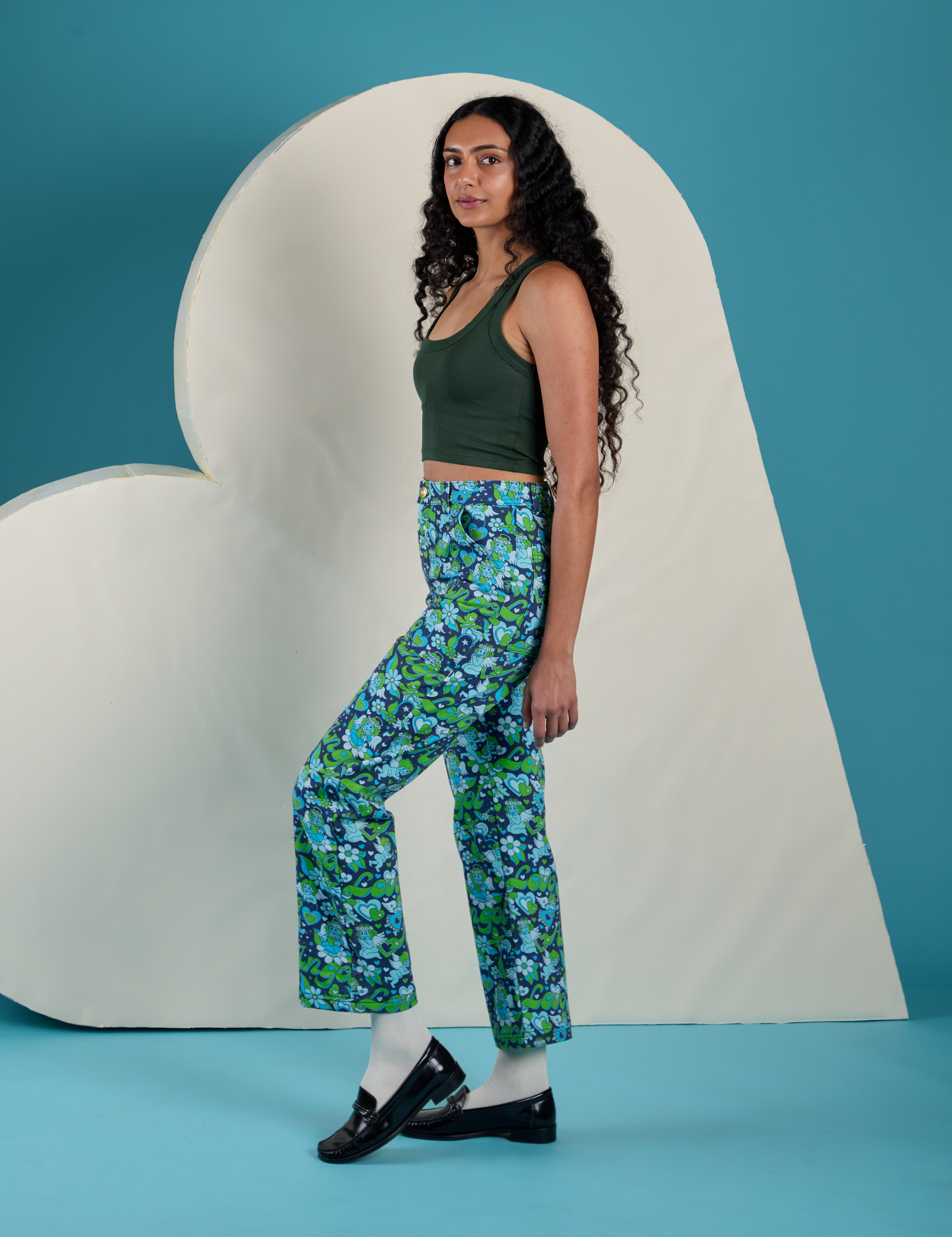 Side view of Work Pants in Angel Print and Cropped Tank in Swamp Green on Shahana