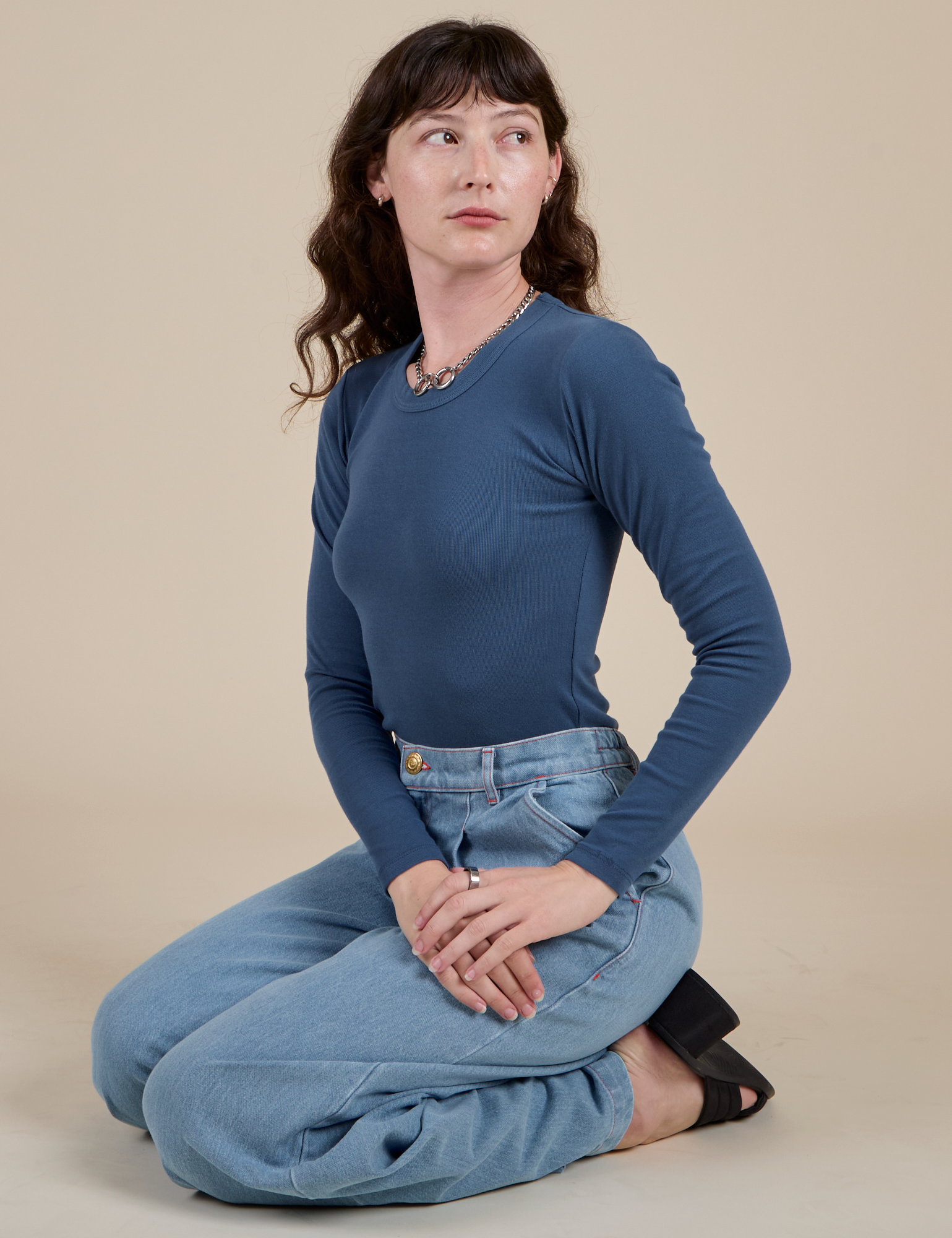 Alex is wearing Long Sleeve Baby Tee in French Blue