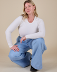 Lish is wearing Long Sleeve Baby Tee in Vintage Tee Off-White paired with light wash Indigo Wide Leg Trousers