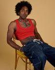 Jerrod is wearing Contrast Stitch Mini Tank in Mustang Red and dark wash Denim Drop Pocket Pants