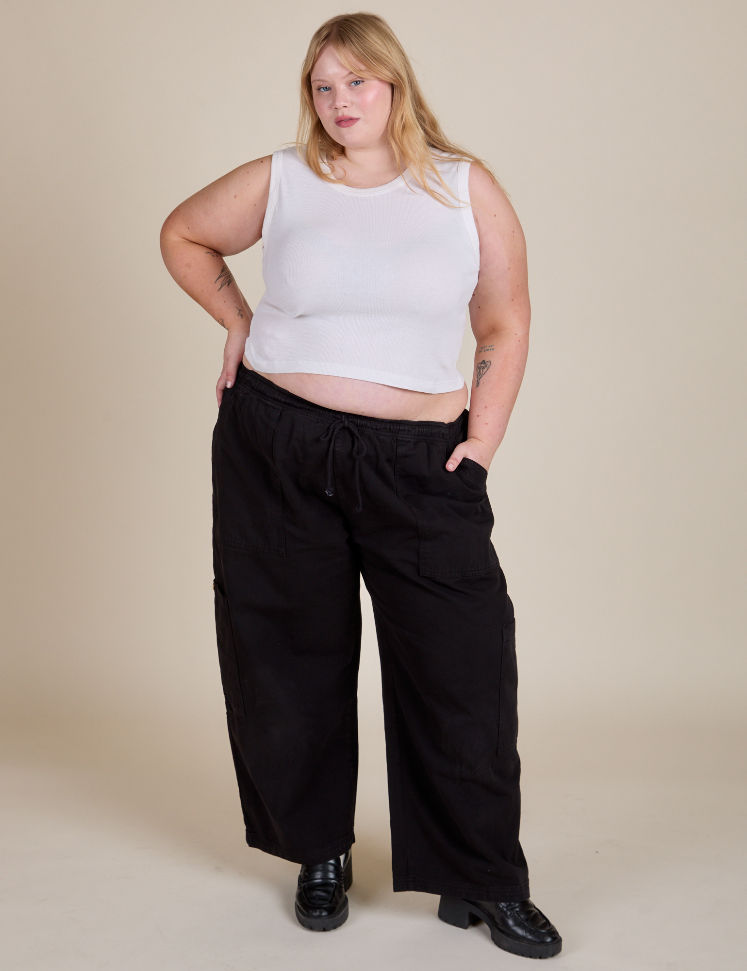 Juliet is wearing Muscle Tee in Vintage Tee White and black Drop Pocket Cargo Pants