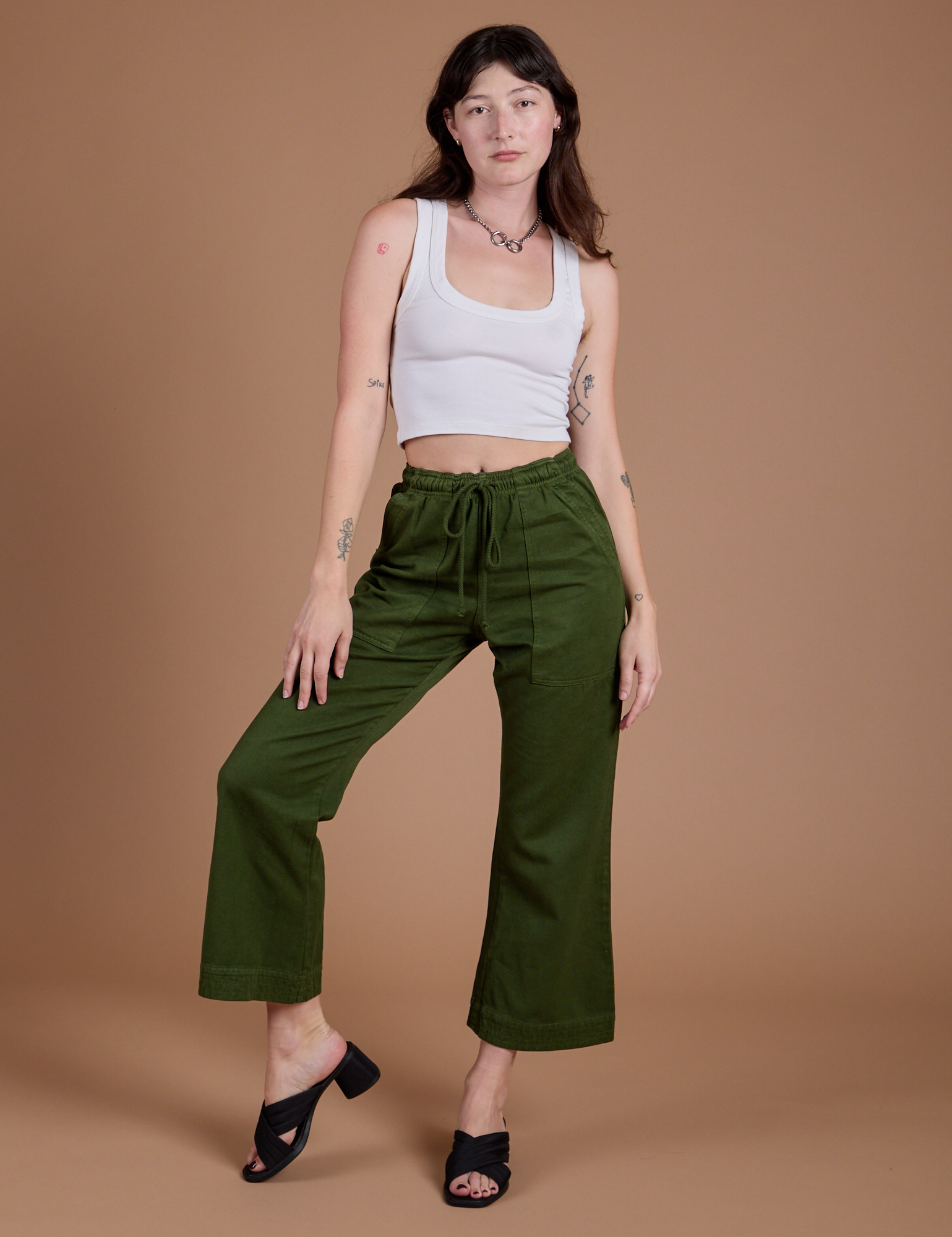 Organic Action Pants in Evergreen and vintage tee white Cropped Tank on Alex