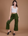Organic Action Pants in Evergreen and vintage tee white Cropped Tank on Alex