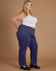 Side view of Railroad Denim Work Pants in Faded Grape Overdye and vintage tee white Cropped tank on Juliet