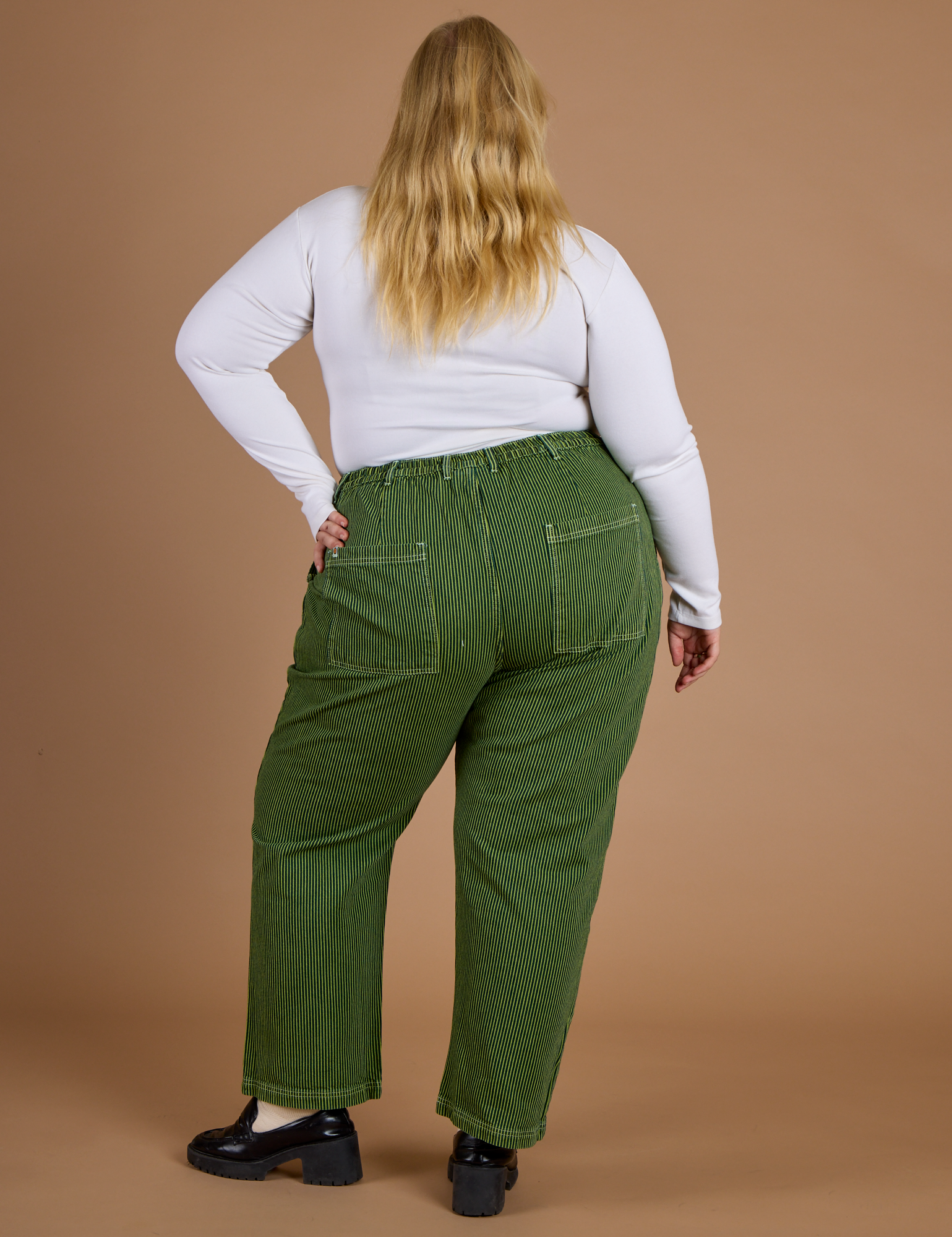 Railroad Denim Work Pants in Gross Green Overdye back view on Juliet