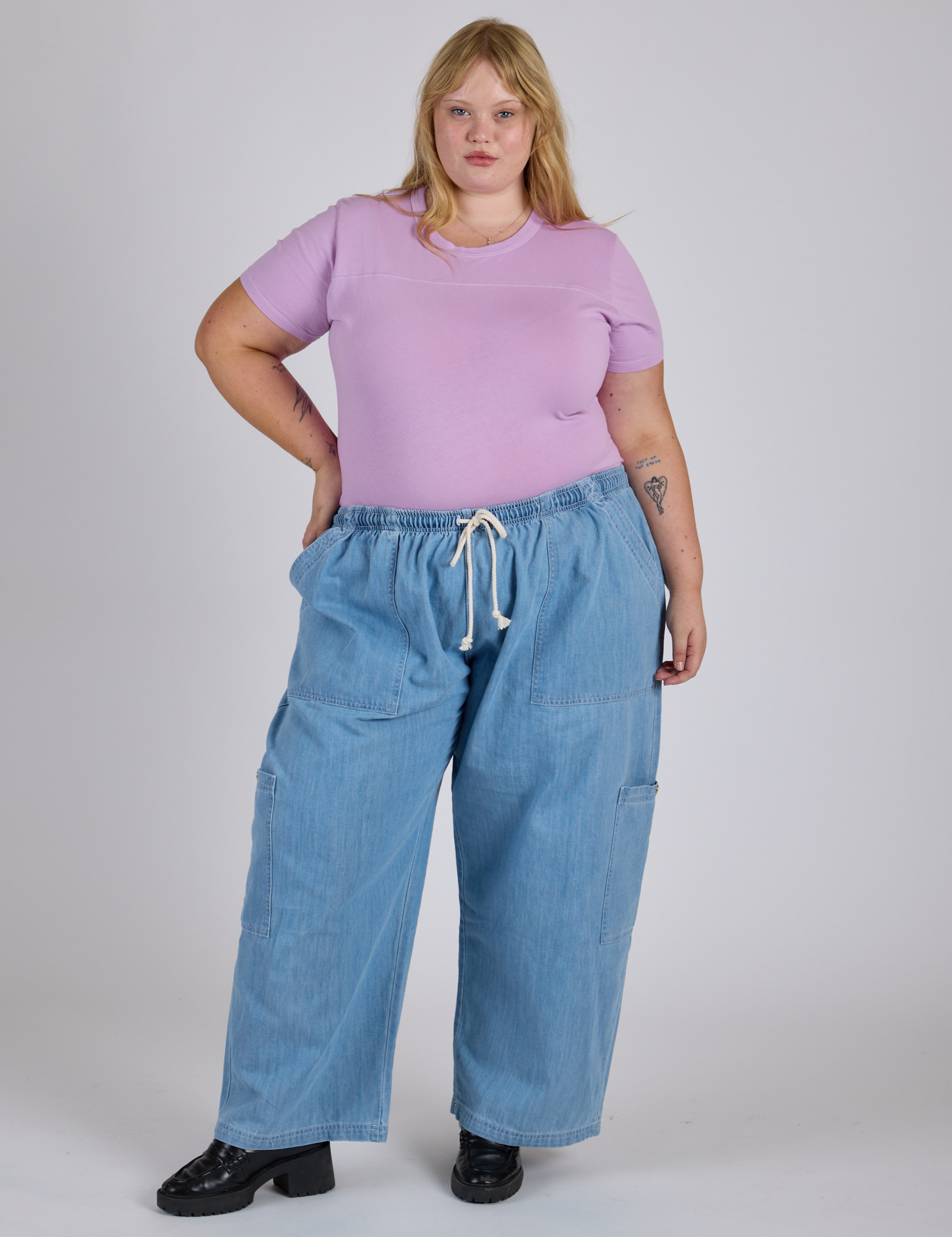 Juliet is wearing Jr. Varsity Tee in Lilac Purple and light wash Denim Drop Pocket Pants