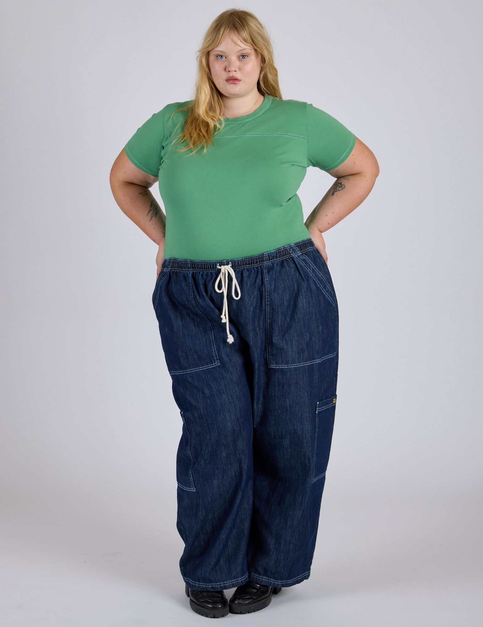 Juliet is wearing Jr. Varsity Tee in Seafoam Green tucked into dark wash Denim Drop Pocket Pants