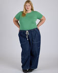 Juliet is wearing Jr. Varsity Tee in Seafoam Green tucked into dark wash Denim Drop Pocket Pants