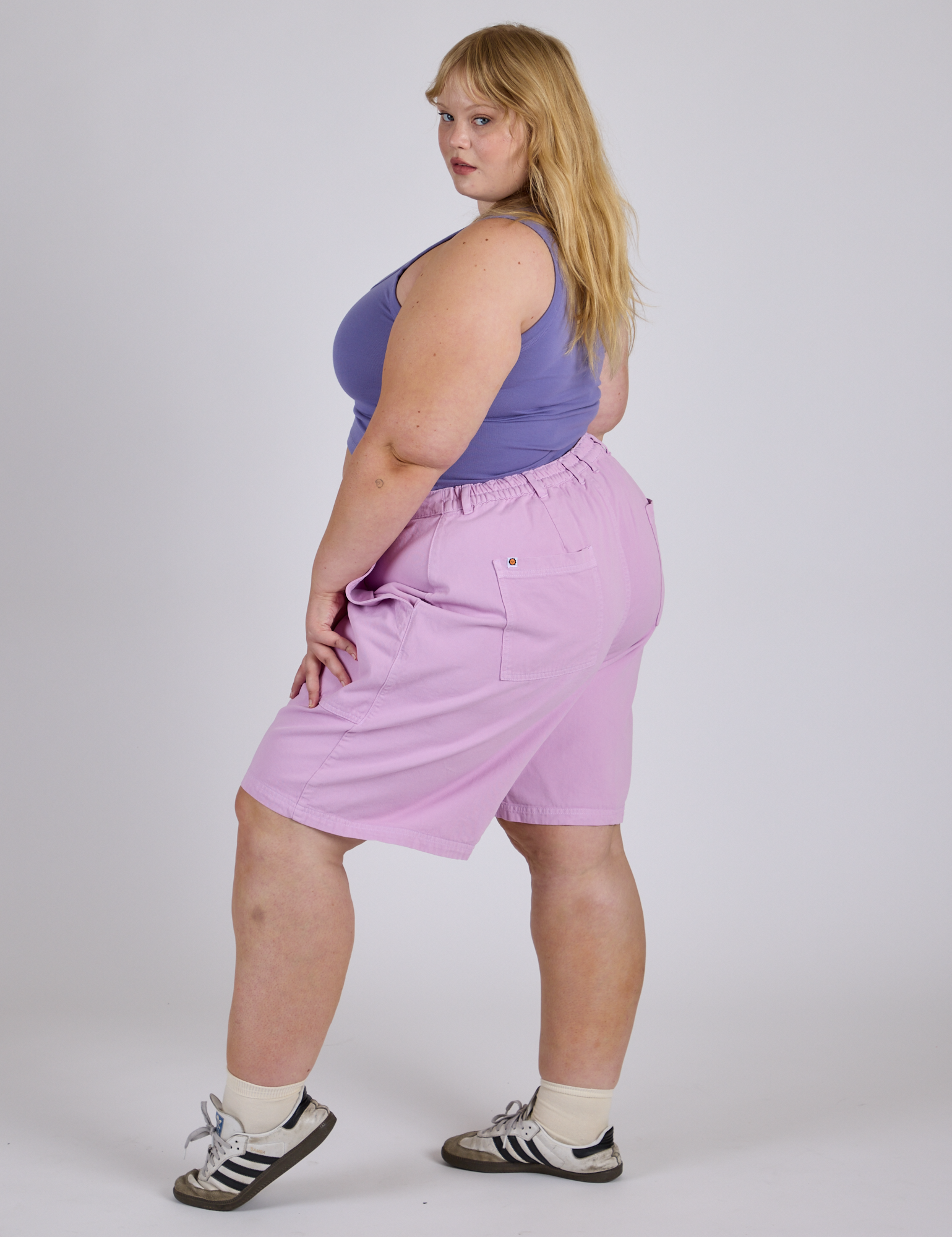 Side view of Longline Work Shorts in Lilac Purple and faded grape Cropped Tank on Juliet