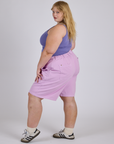 Side view of Longline Work Shorts in Lilac Purple and faded grape Cropped Tank on Juliet
