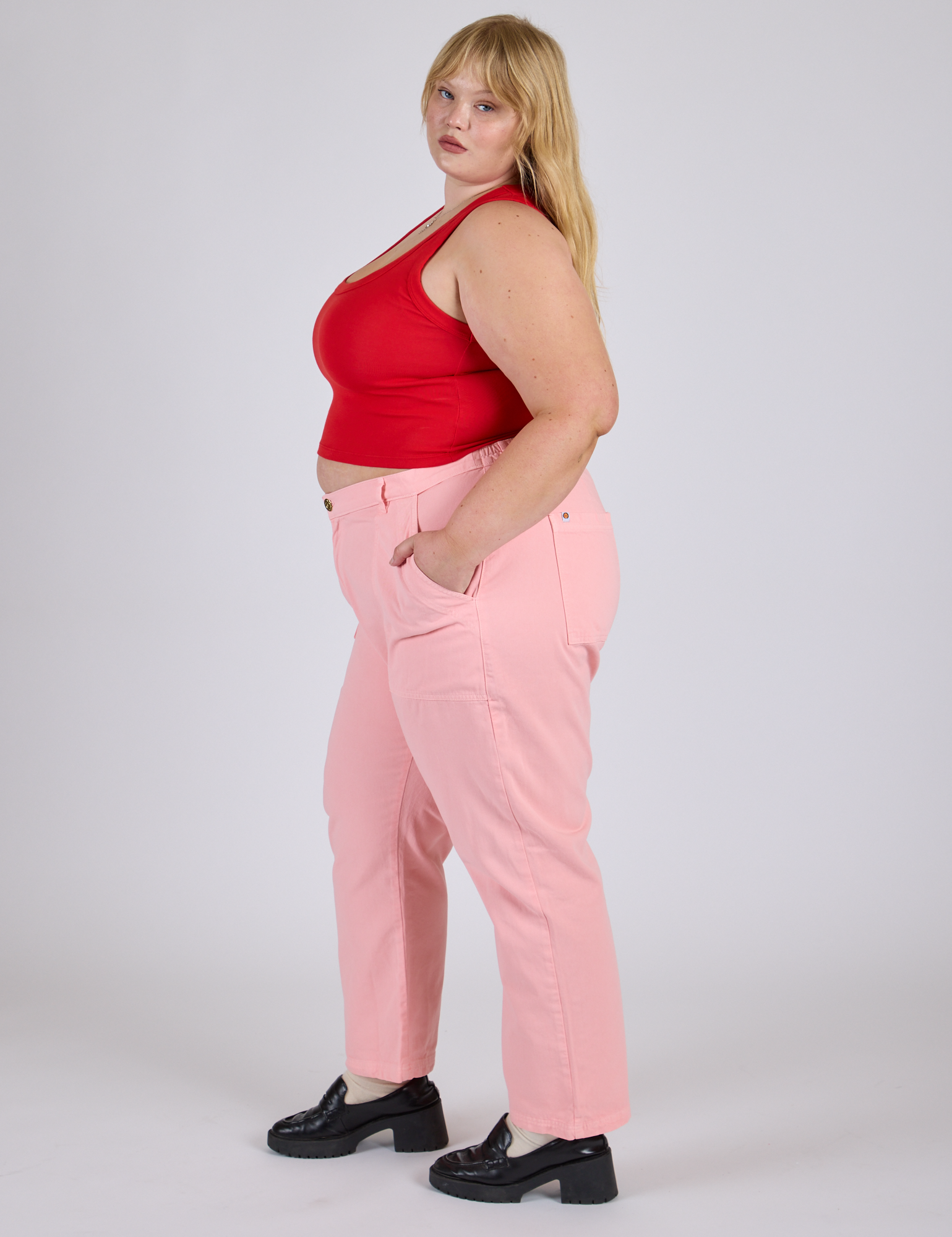 Side view of Work Pants in Baby Pink and mustang red Cropped Tank on Juliet