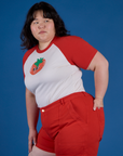 Angled front view of Produce Raglan Tee in Tomato on Ashley