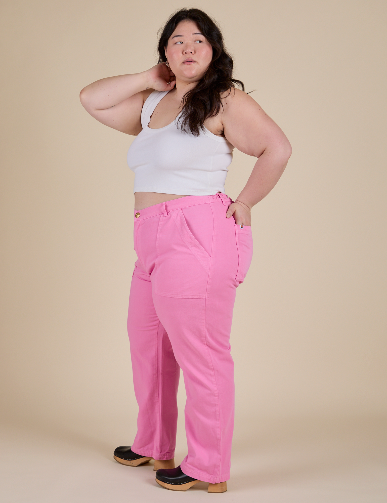 Side view of  Work Pants in Bubblegum Pink and Cropped Tank in Vintage Tee White on Ashley