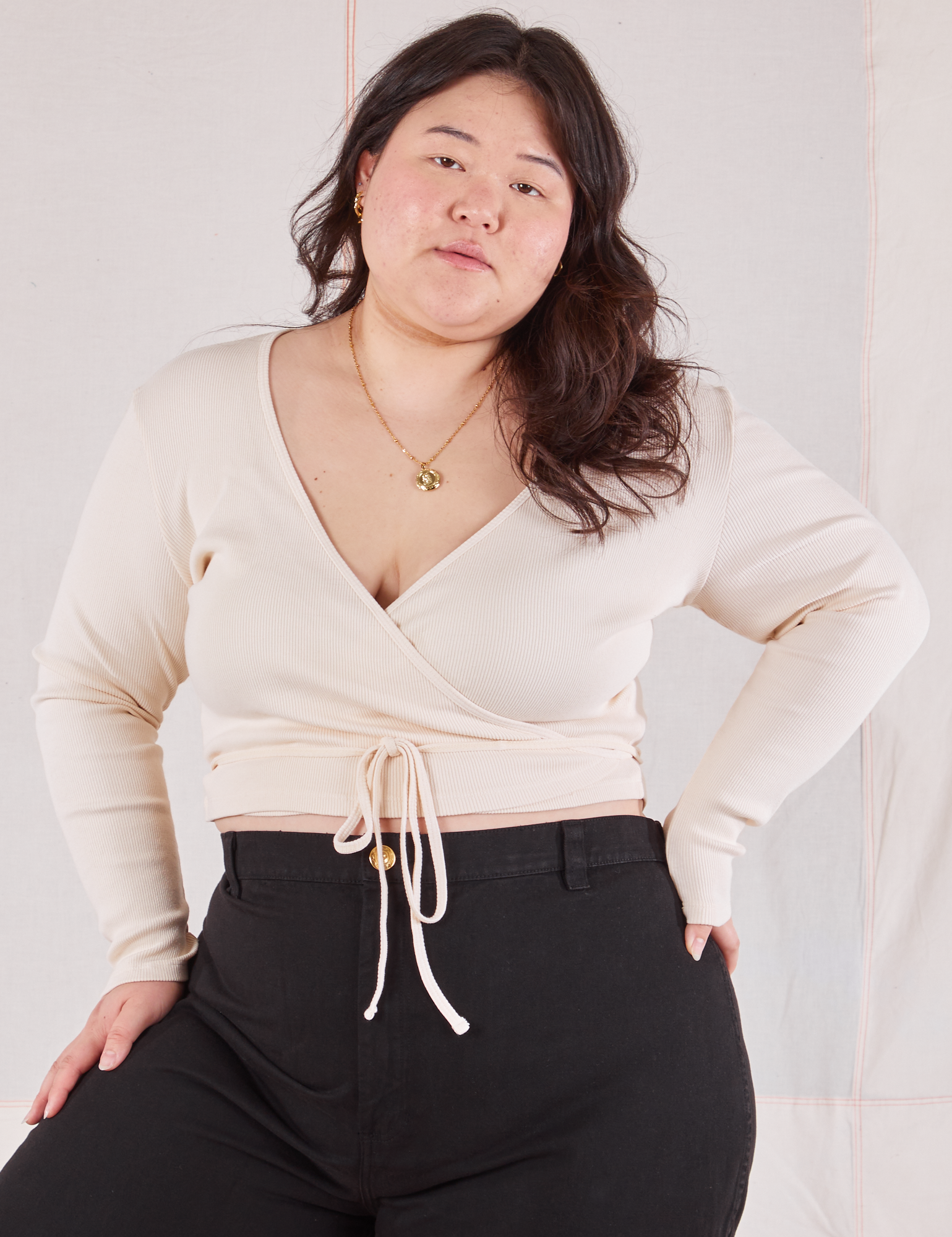 Ashley is 5'7" and wearing size 4 Wrap Top in Vintage Tee Off-White