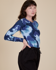 Long Sleeve Baby Tee in Blue Magic Waters side view on Alex