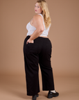Angled back view of Organic Action Pants in Basic Black on Juliet