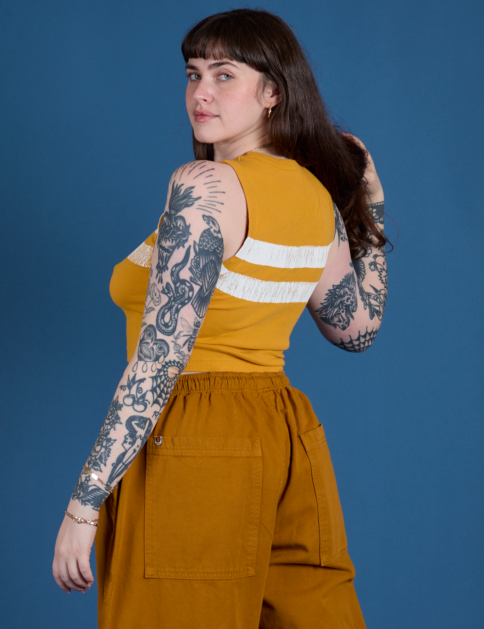 Painted Muscle Tee in Mustard Yellow angled back view on Sydney