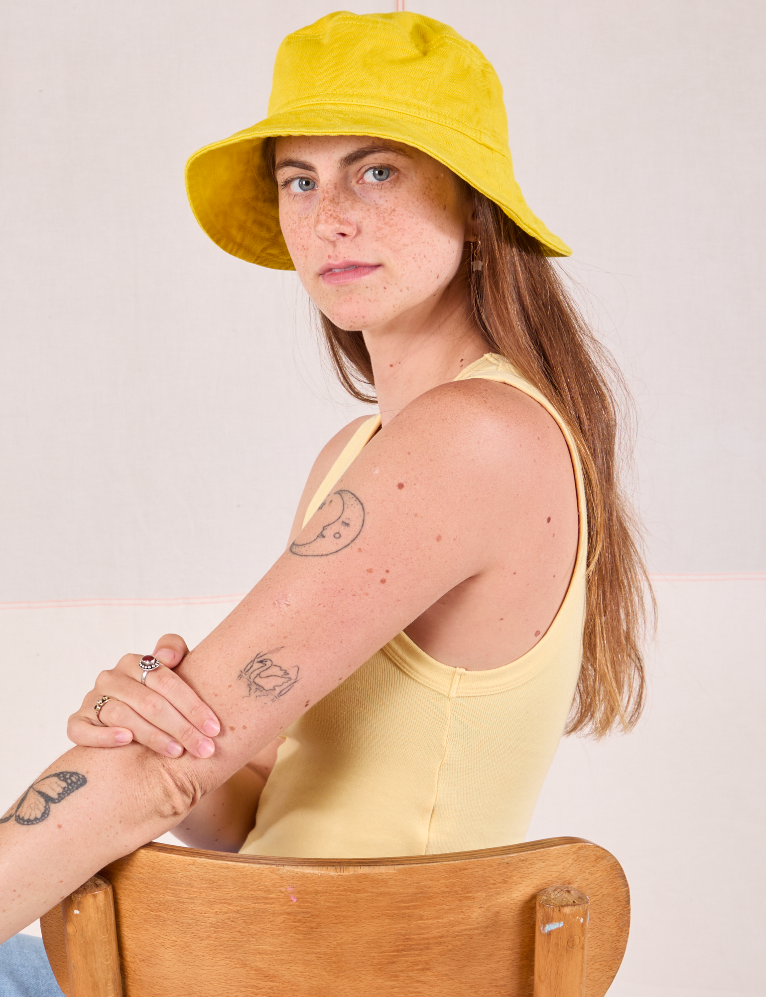 Scarlett is wearing Wide Brim Denim Bucket Hats in Golden Yellow