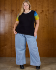 Juliet is 5'7" and wearing L Calypso Tee in Black Multi paired with light wash denim wide leg trousers