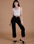 Alex is 5’8” and wearing XXS Carpenter Jeans in Black paired with a Cropped Tank in Vintage Tee White