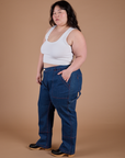 Angled front view of Carpenter Jeans in Dark Wash and Cropped Tank in Vintage Tee White on Ashley