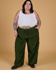Sam is 5'10" and wearing 2XL Corduroy Drop Pocket Cargo Pants in Evergreen paired with a Cropped Tank in Vintage Tee White