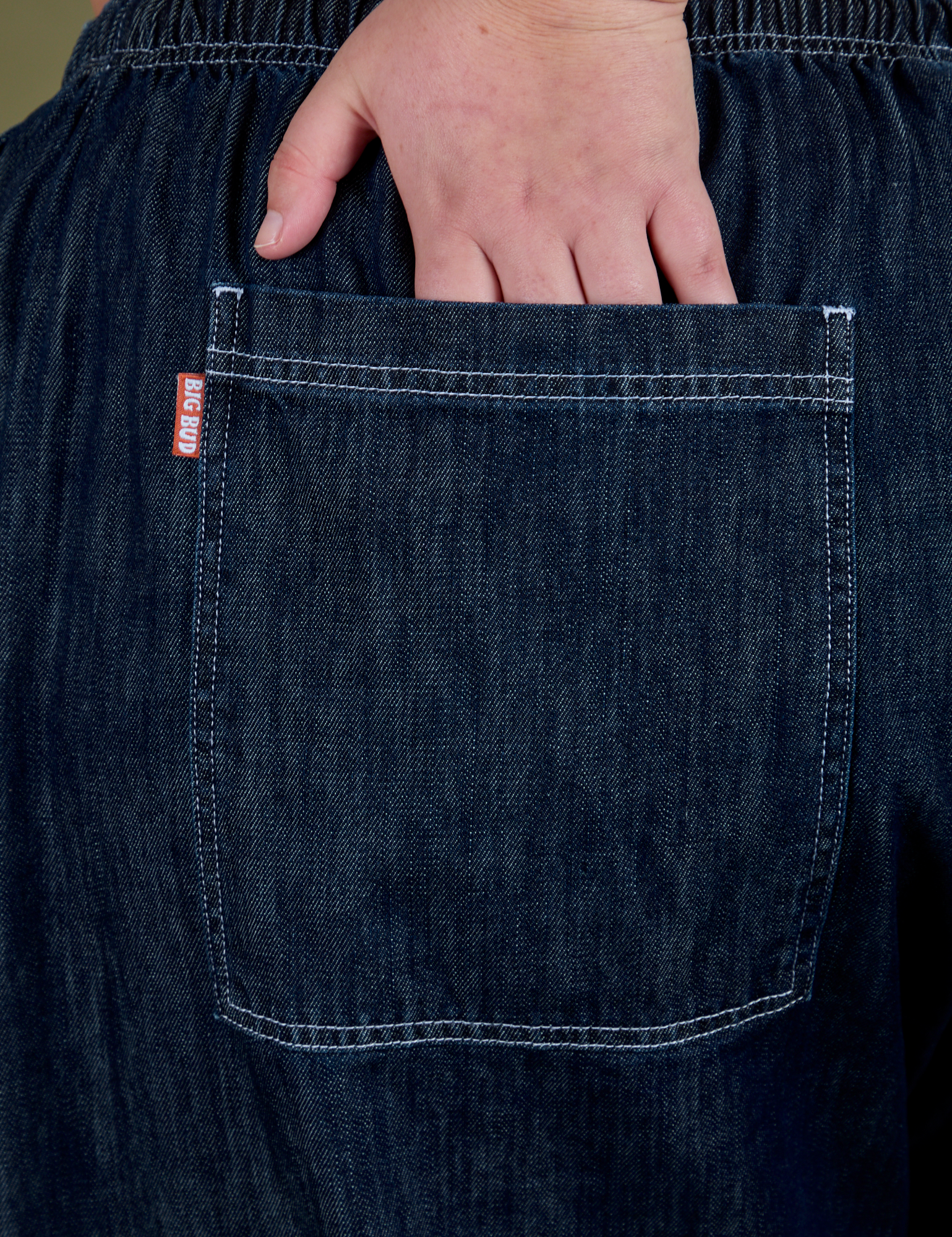 Close up of Juliet's hand in the back pocket of Denim Drop Pocket Pants in Dark Wash