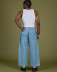 Back view of Denim Drop Pocket Pants in Light Wash and Cropped Tank in Vintage Tee White on Isaac