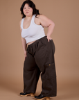 Angled front view of Drop Pocket Cargo Pants in Espresso Brown and Cropped Tank in vintage tee white on Ashley