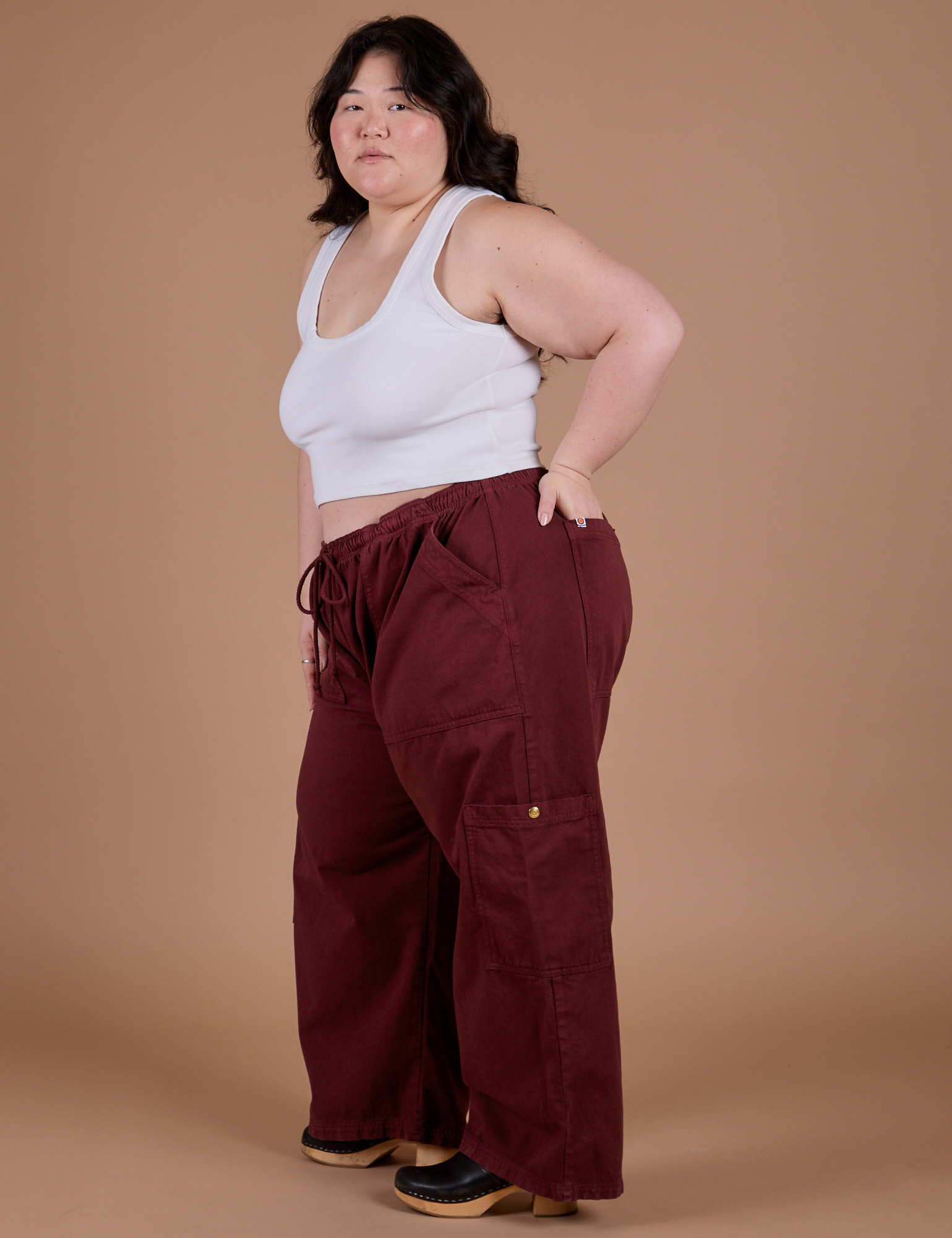 Side view of Drop Pocket Cargo Pants in Red Wine and vintage tee white Cropped Tank on Ashley