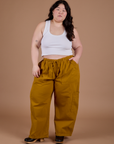 Ashley is wearing Drop Pocket Cargo Pants in Spicy Mustard and Cropped Tank in Vintage Tee White