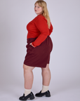Side view of Pleated Trouser Shorts in Red Wine and Long Sleeve Gingham Baby Tee in Mustang Red